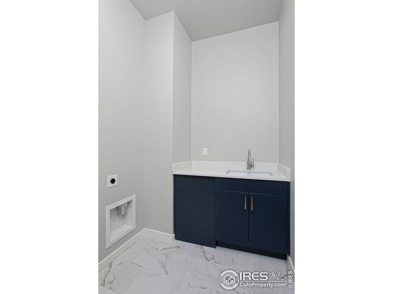 Laundry Room with base cabinets & sink