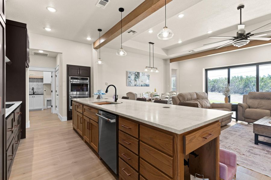 Kitchen featuring open floor plan, appliances with stainless steel finishes, ceiling fan, recessed lighting, and a sink Kitchen featuring open floor plan, appliances with stainless steel finishes, ceiling fan, recessed lighting, and a sink