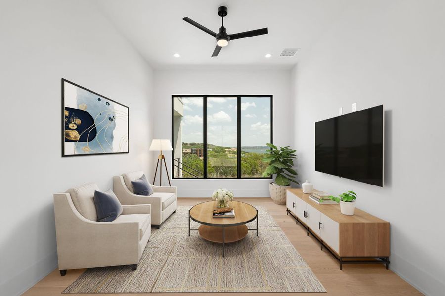 Virtually staged sitting room offers high ceilings, light hardwood floors, and a beautiful outdoor view.