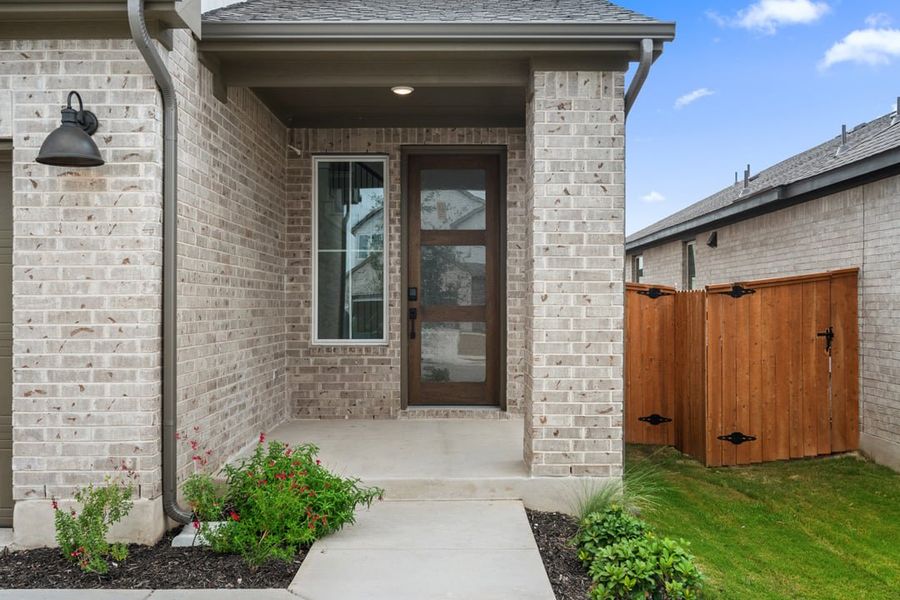 Front exterior of a new home in Terrace Collection at Lariat, Liberty Hill, TX, highlighting curb appeal (Image 24). Front exterior of a new home in Terrace Collection at Lariat, Liberty Hill, TX, highlighting curb appeal (Image 24).