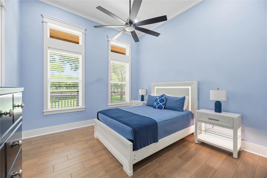 Spacious bedroom retreat featuring soaring ceilings, oversized windows, and elegant designer finishes.