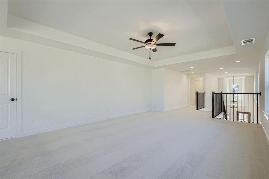 Spare room featuring a tray ceiling, carpet flooring, recessed lighting, and a ceiling fan Spare room featuring a tray ceiling, carpet flooring, recessed lighting, and a ceiling fan