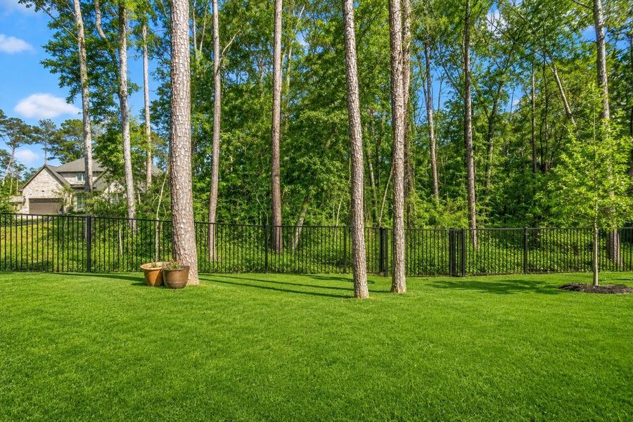Your covered patio offers a serene, wooded view, providing privacy and a natural backdrop.