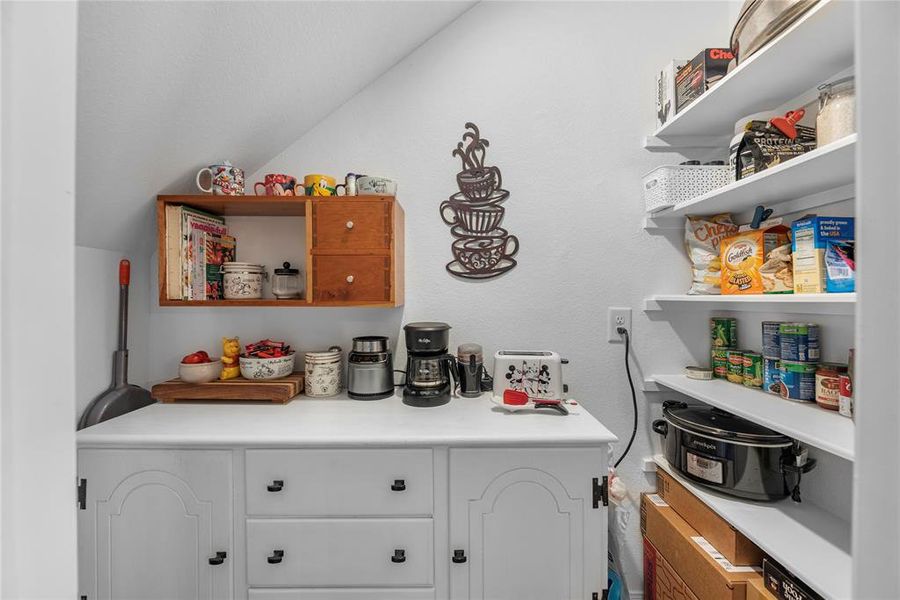 The room under the stairs is used as a coffee bar and pantry.