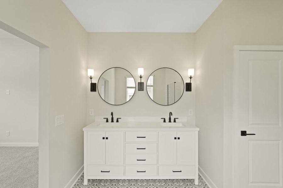Primary bath featuring freestanding vanity with dual sinks