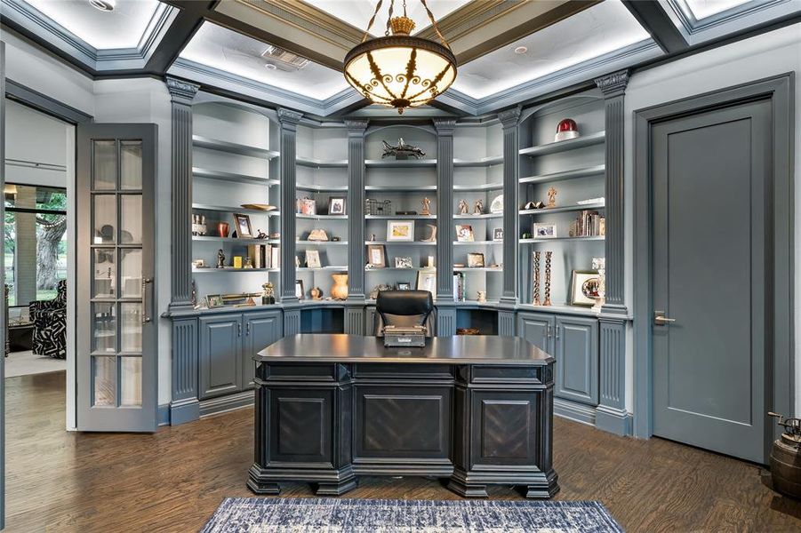 Office space with built in features, crown molding, and dark wood-type flooring