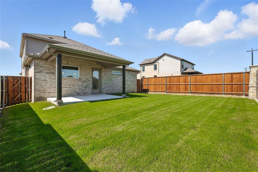 Rear view of property featuring a patio area, a fenced backyard, and brick siding Rear view of property featuring a patio area, a fenced backyard, and brick siding