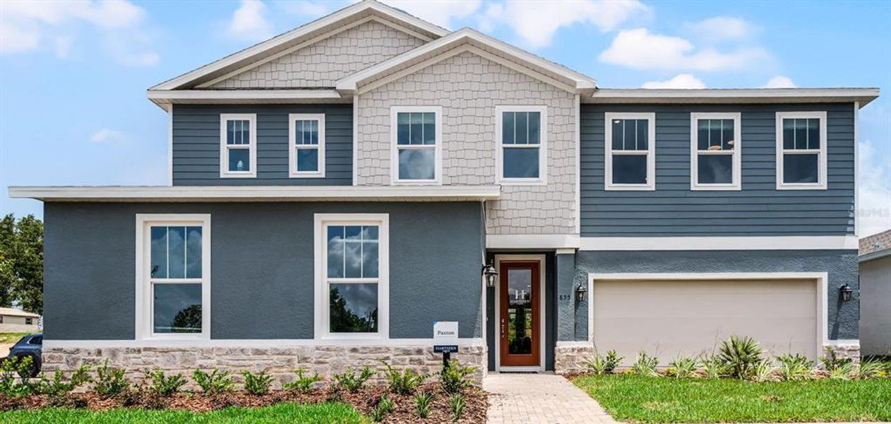 Front exterior of a new home in Eden Crest, Apopka, FL, highlighting curb appeal (Image 1).