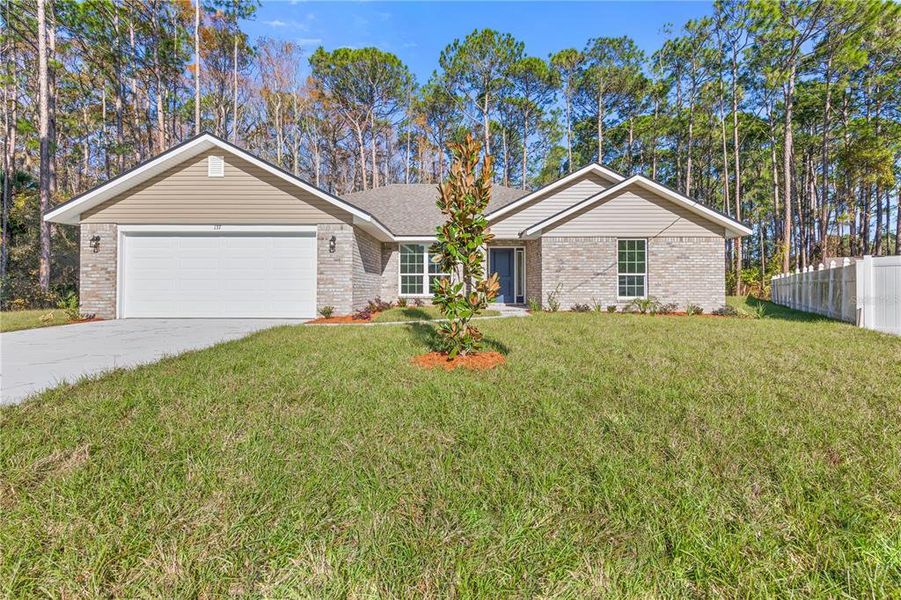 Front exterior of a new home in Palm Coast, Palm Coast, FL, highlighting curb appeal (Image 16). Front exterior of a new home in Palm Coast, Palm Coast, FL, highlighting curb appeal (Image 16).