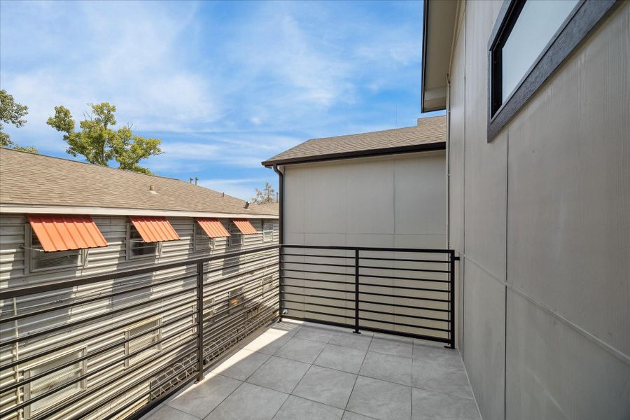 Step out to a private balcony finished with durable tile flooring and modern metal railing. The space offers a quiet outdoor retreat, perfect for morning coffee or evening relaxation.