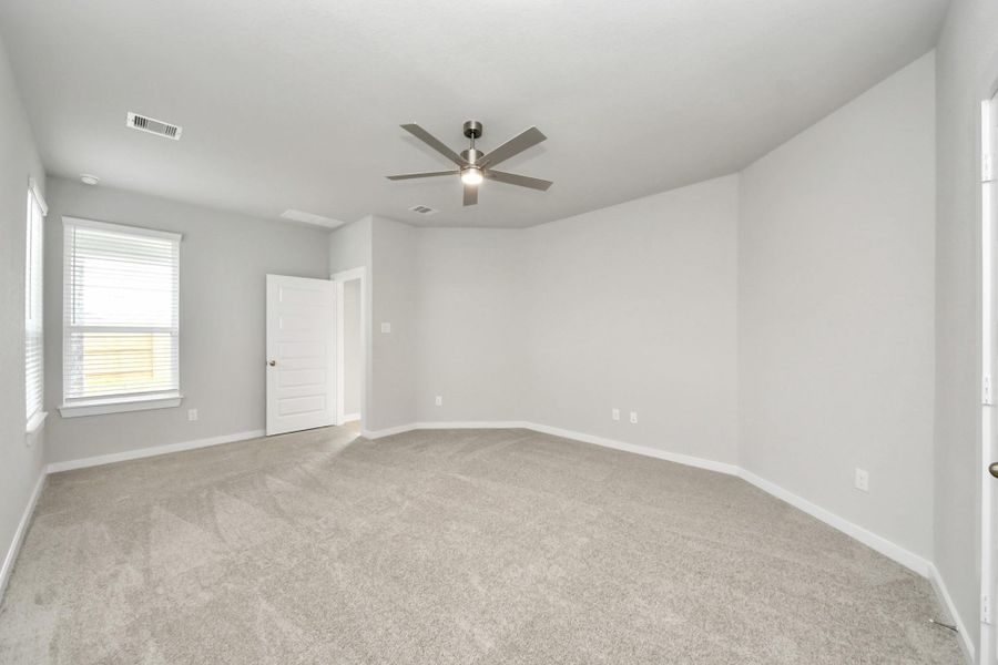 Come and unwind after a long day in this magnificent primary suite! This spacious room features plush carpet, warm paint, high ceilings and large windows with privacy blinds.