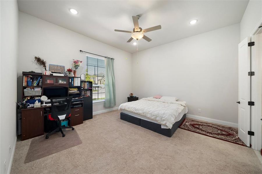 Bedroom with light carpet and ceiling fan