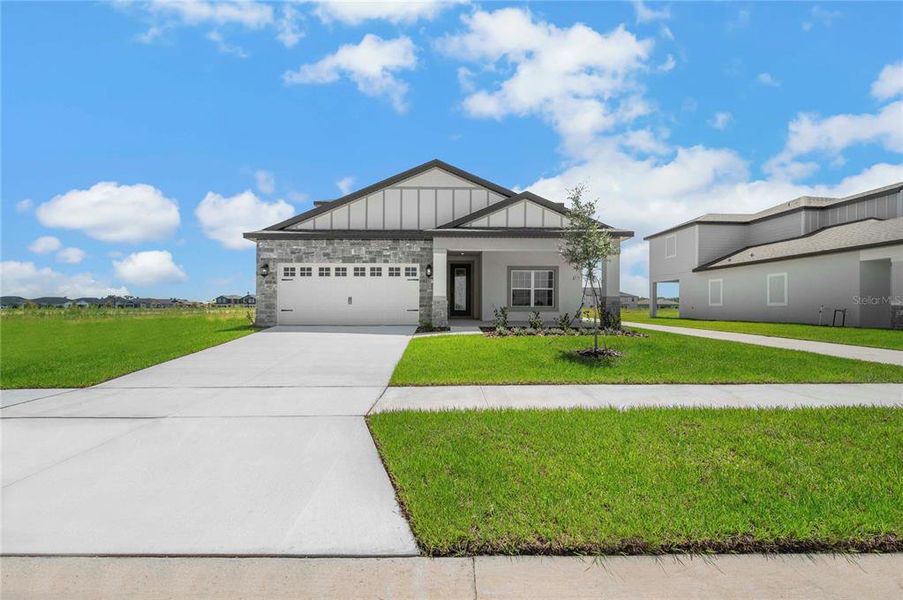 Front exterior of a new home in Gum Lake Preserve, Lake Alfred, FL, highlighting curb appeal (Image 20).