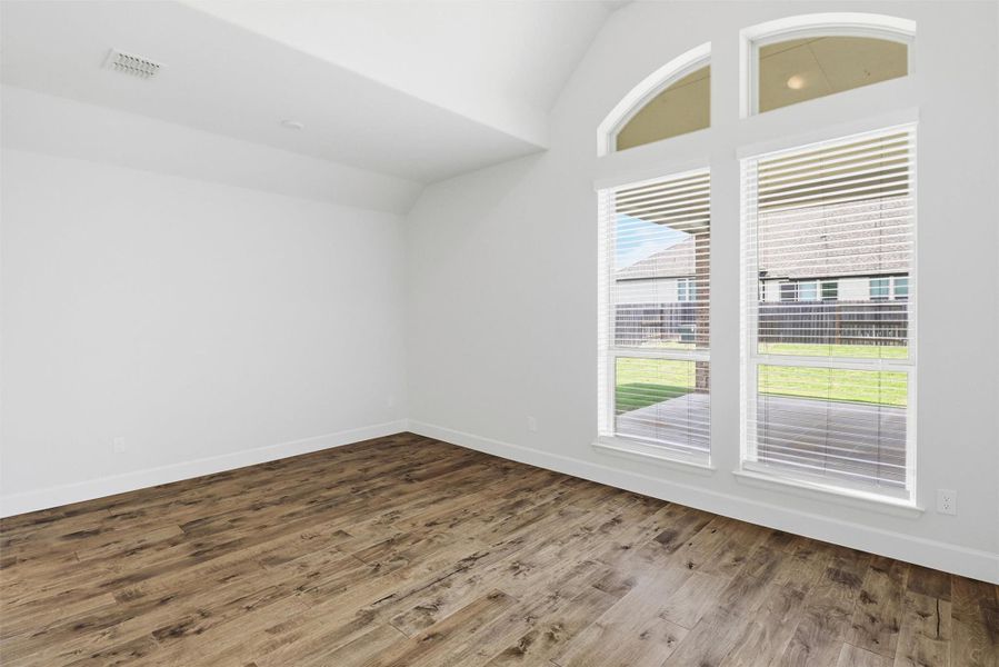 Guest bedroom with private bath which is tucked towards the back of the home.