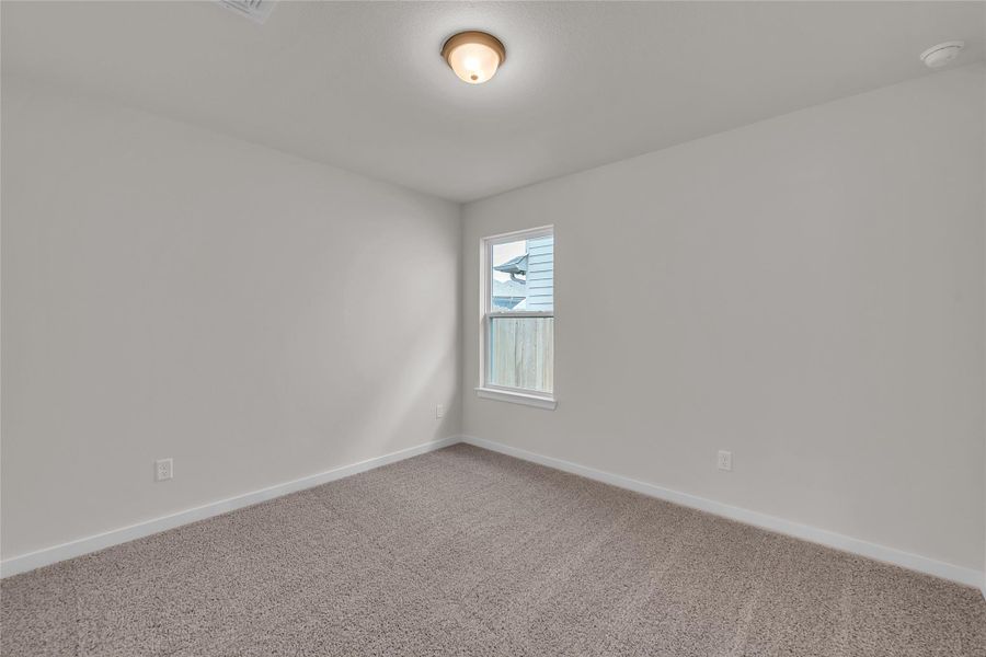 Empty room featuring carpet and baseboards Empty room featuring carpet and baseboards
