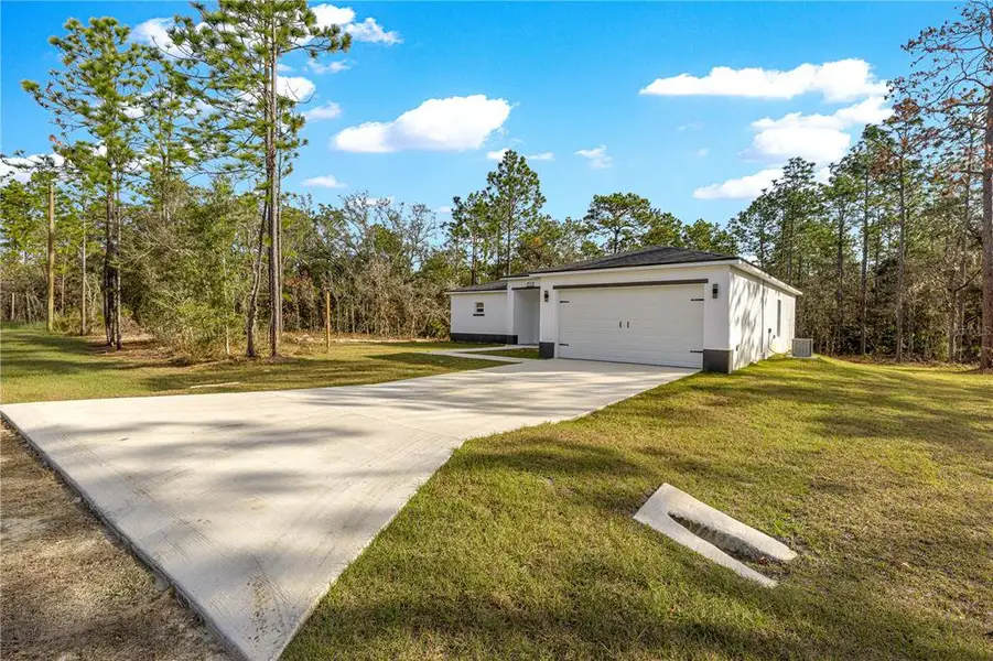 Front exterior of a new home in , Dunnellon, FL, highlighting curb appeal (Image 2). Front exterior of a new home in , Dunnellon, FL, highlighting curb appeal (Image 2).