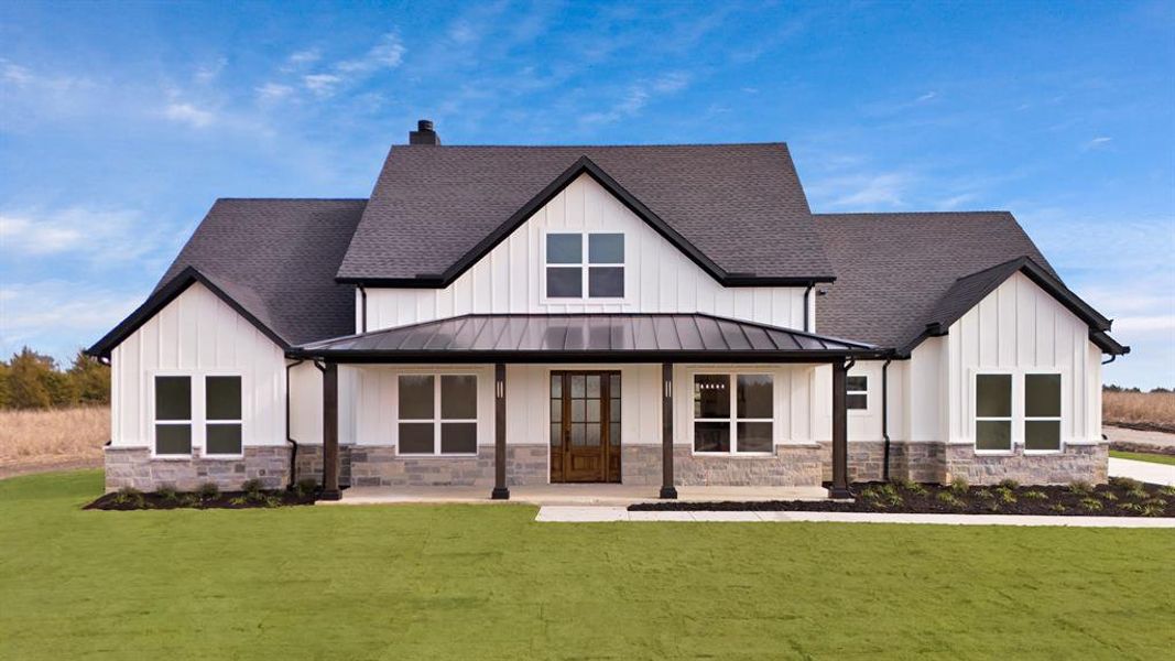 View of front facade featuring a front lawn and a porch