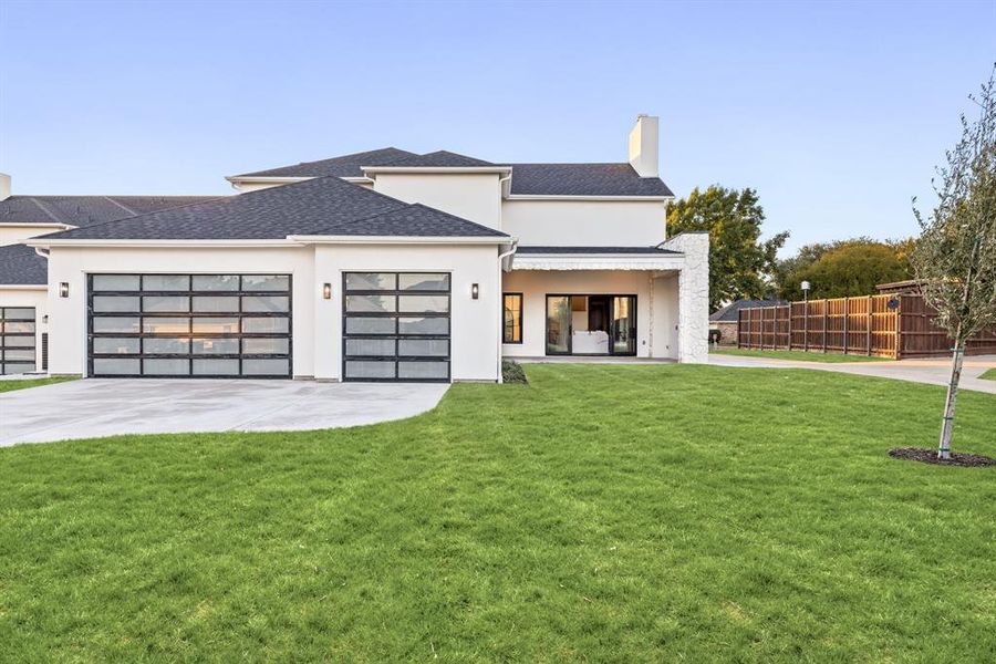 View of front of property featuring stucco siding, a chimney, concrete driveway, an attached garage, and roof with shingles View of front of property featuring stucco siding, a chimney, concrete driveway, an attached garage, and roof with shingles