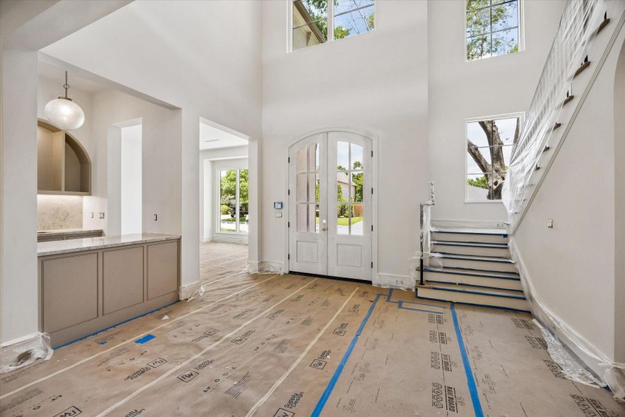 The foyer welcomes you with charming elegance and abundant natural light, and will feature the Aiden Large Chandelier by Visual Comfort.
