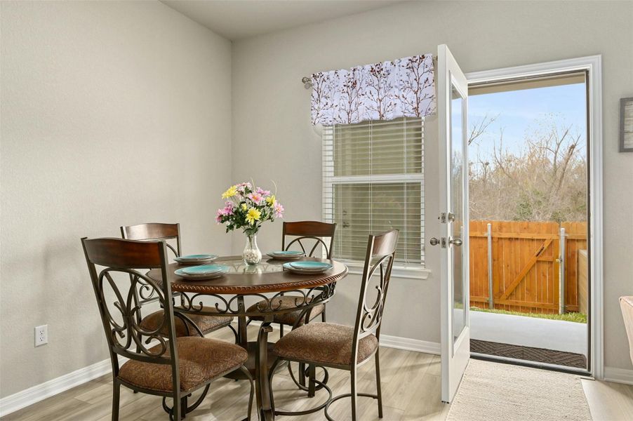 Dining area with light hardwood / wood-style flooring