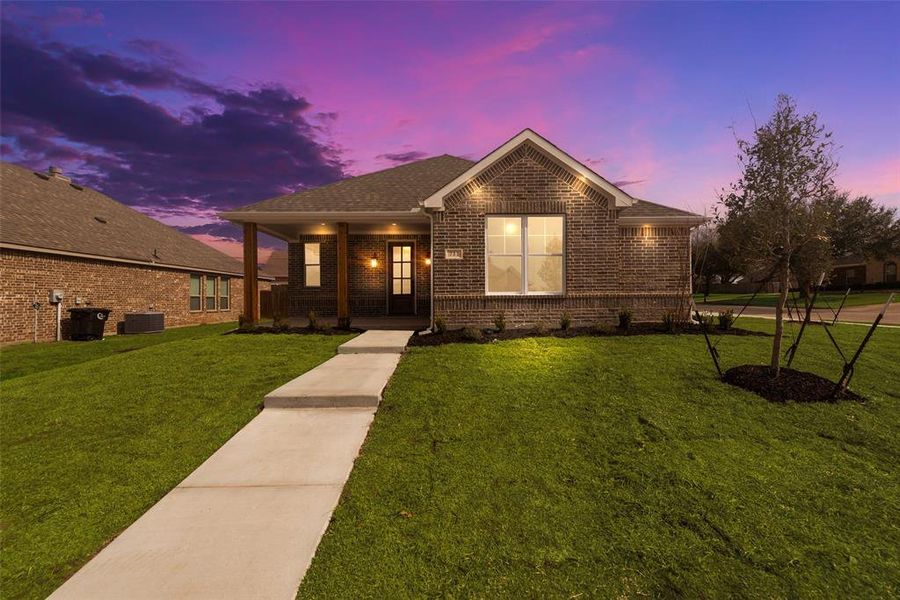 View of front of property featuring central AC and a lawn