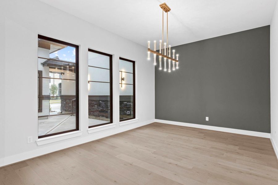 The accent wall in the dining room closely matches the color of the stone in the courtyard. This home has been so thoughtfully designed.
