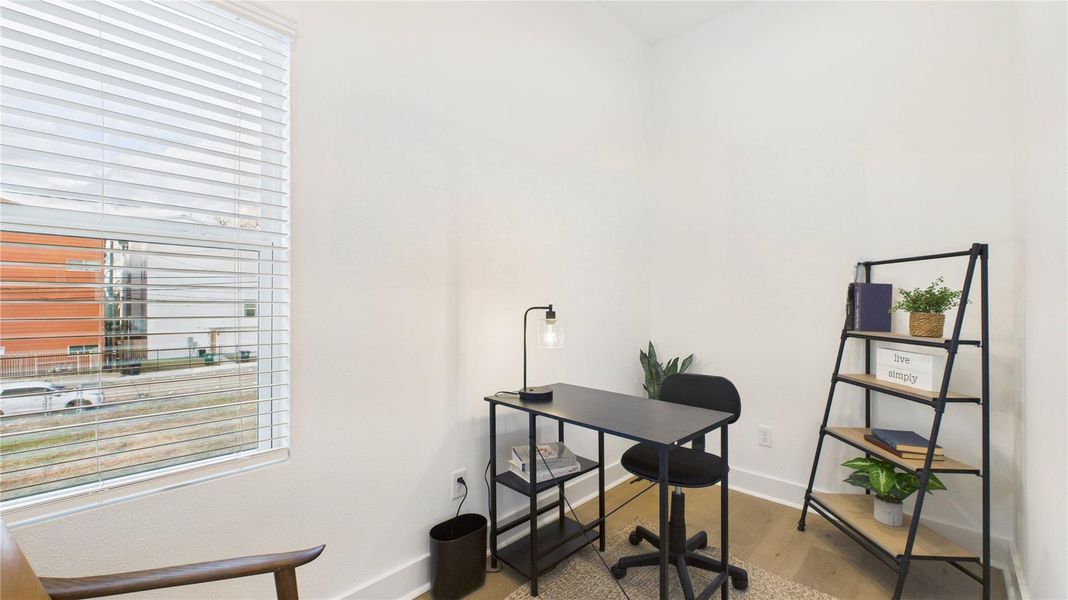 This independent study, conveniently located just off the kitchen, offers a quiet and functional space ideal for a home office, reading room, or creative workspace.
