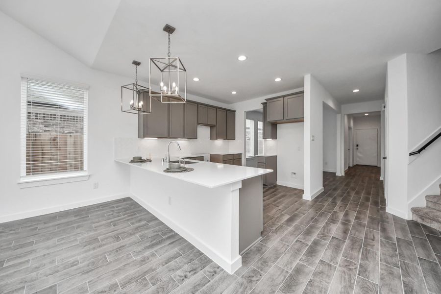 The open concept effortlessly connects the kitchen to the expansive family room, forming a perfect hub for gatherings. This seamless flow creates an inviting space where cooking and socializing come together harmoniously. Sample photo of completed home with similar floor plan. Actual colors and selections may vary.