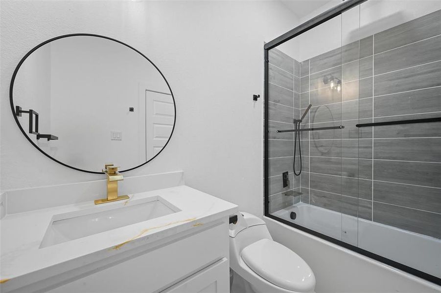 Bathroom with vanity and combined bath / shower with glass door Bathroom with vanity and combined bath / shower with glass door