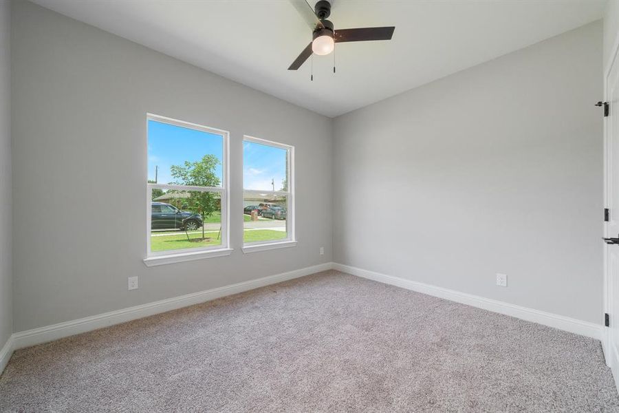 Empty room with ceiling fan and carpet floors