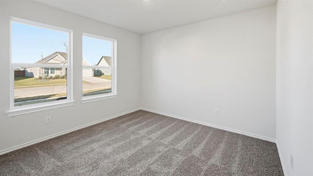 Empty room with carpet floors and baseboards