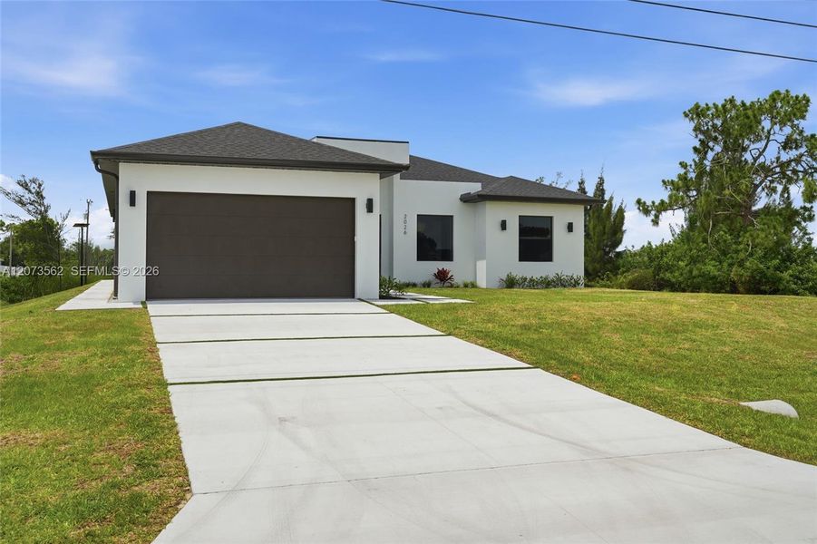 Front exterior of a new home in , Cape Coral, FL, highlighting curb appeal (Image 20). Front exterior of a new home in , Cape Coral, FL, highlighting curb appeal (Image 20).