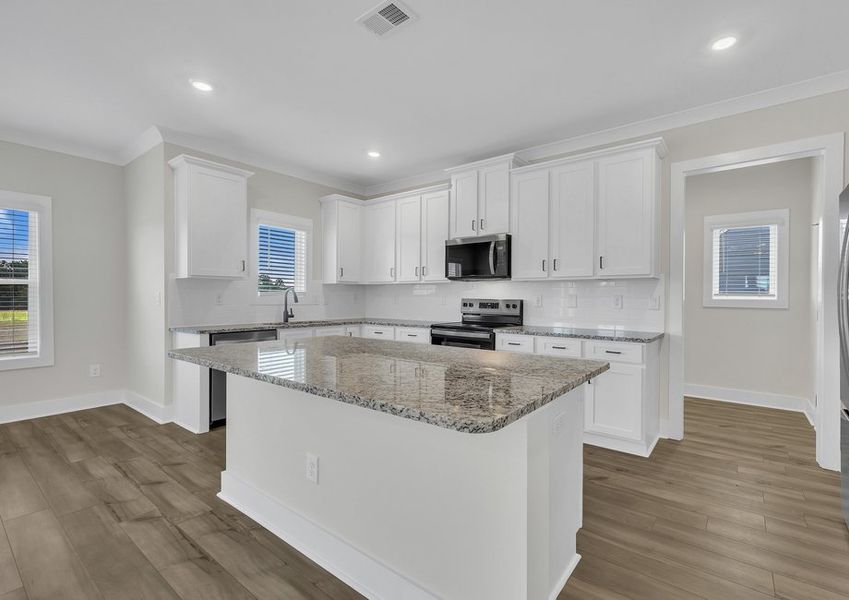 The kitchen has a spacious kitchen island.