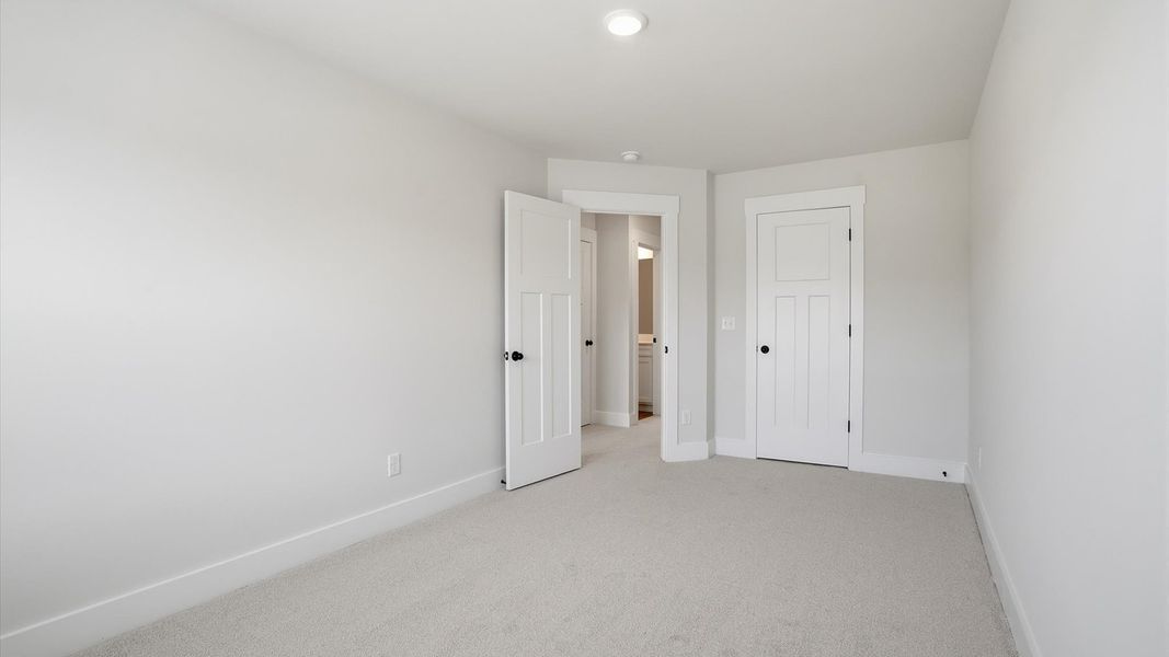 Superior comfort in a secondary bedroom with plush carpet and an oversized walk-in closet in Fountain Inn, SC Superior comfort in a secondary bedroom with plush carpet and an oversized walk-in closet in Fountain Inn, SC