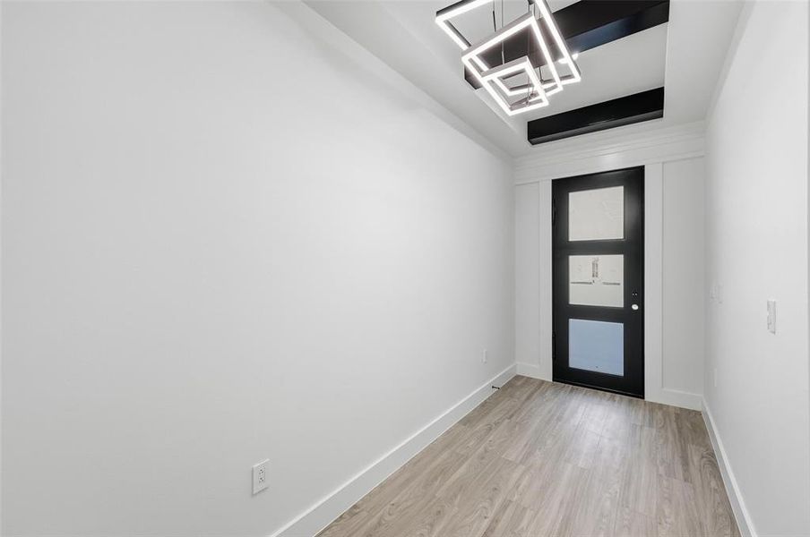 Foyer entrance featuring light wood-style flooring and baseboards Foyer entrance featuring light wood-style flooring and baseboards