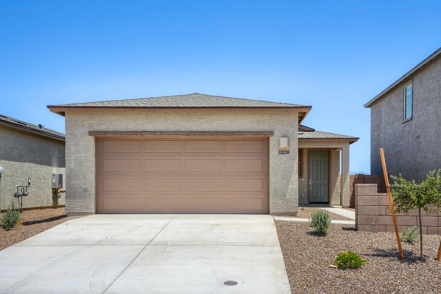 Front exterior of a new home in Springwood at Gladden Farms, Marana, AZ, highlighting curb appeal (Image 1). Front exterior of a new home in Springwood at Gladden Farms, Marana, AZ, highlighting curb appeal (Image 1).