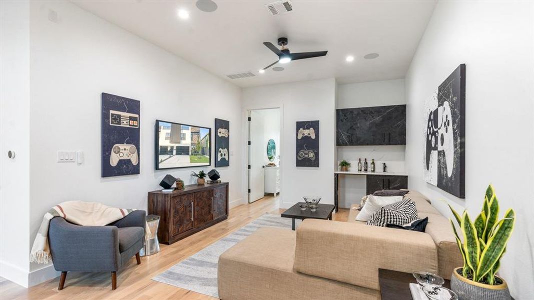 Living room featuring ceiling fan and light hardwood / wood-style flooring