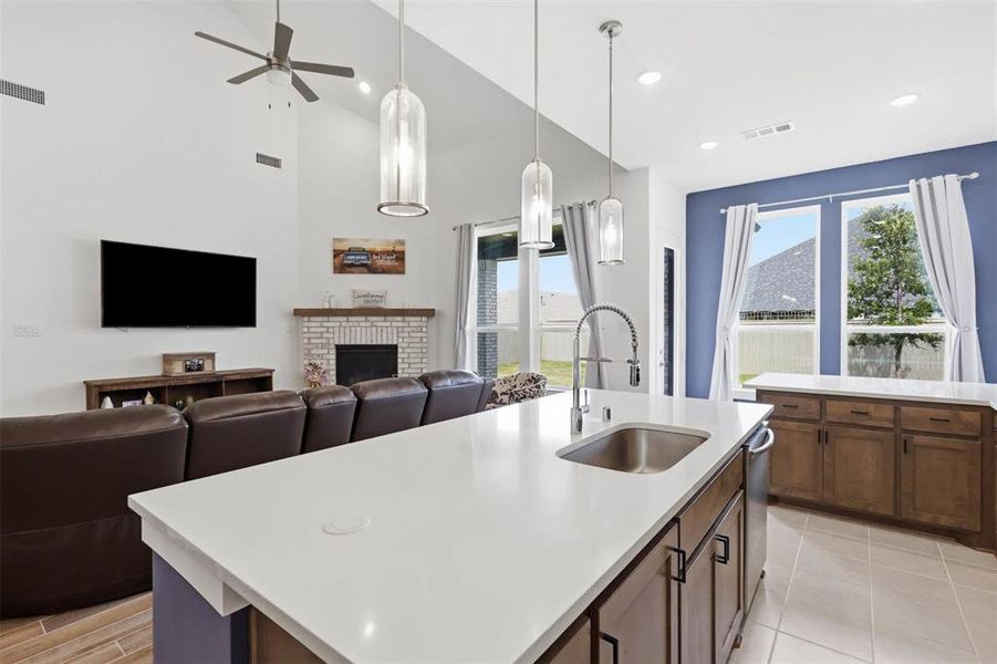 Expansive kitchen island with a built-in sink and pendant lighting