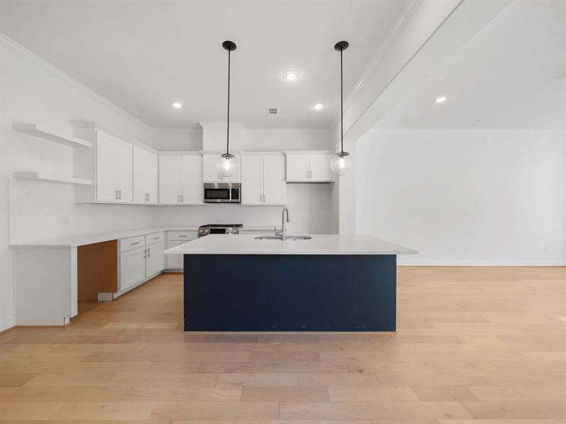 The Bordeaux Kitchen, showcasing custom painted cabinetry, a convenient trash can drawer, and sleek quartz countertops. (Sample photos may include alternative selections and/or upgrades.)