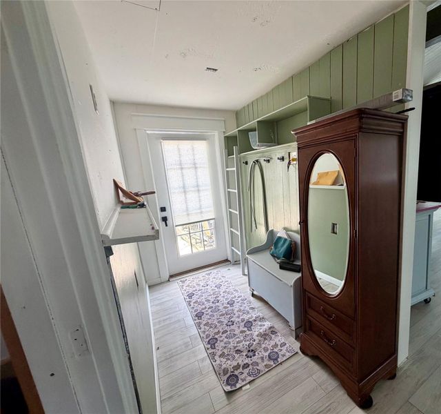 A welcoming entry offers functional built-in shelving and coat hooks, ready for daily convenience.