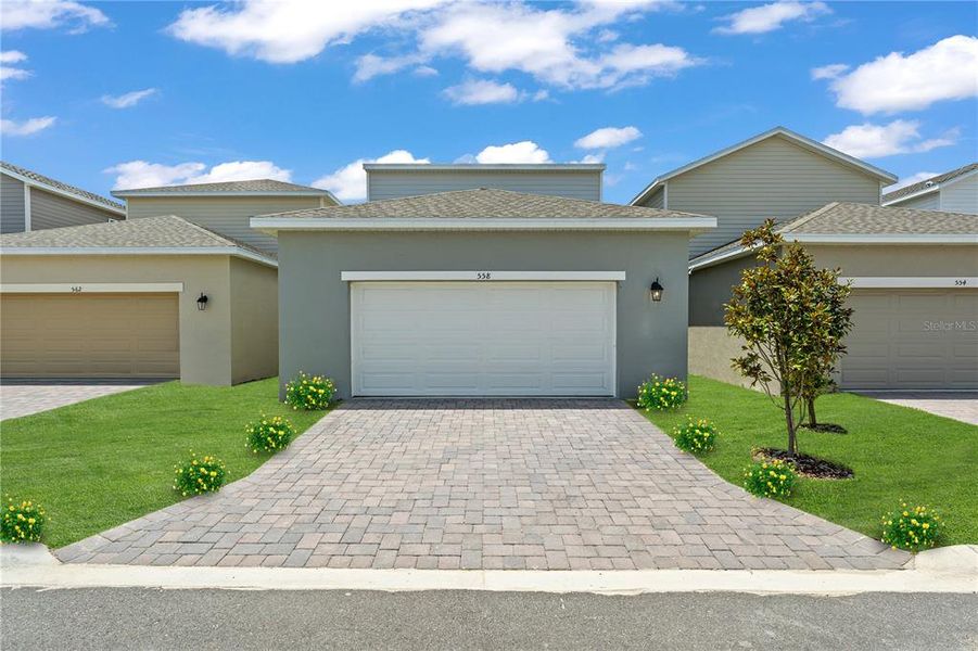 Front exterior of a new home in Spring Walk at the Junction, Debary, FL, highlighting curb appeal (Image 27).