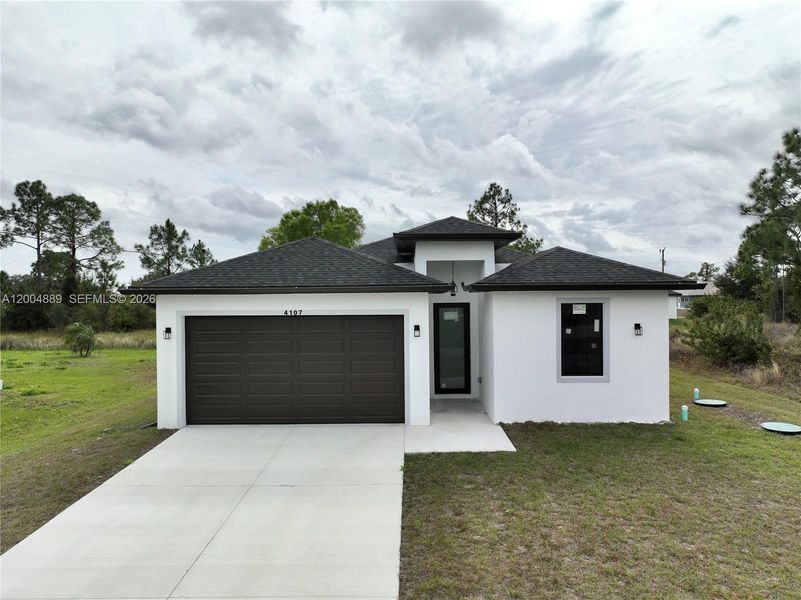 Front exterior of a new home in , Lehigh Acres, FL, highlighting curb appeal (Image 25).