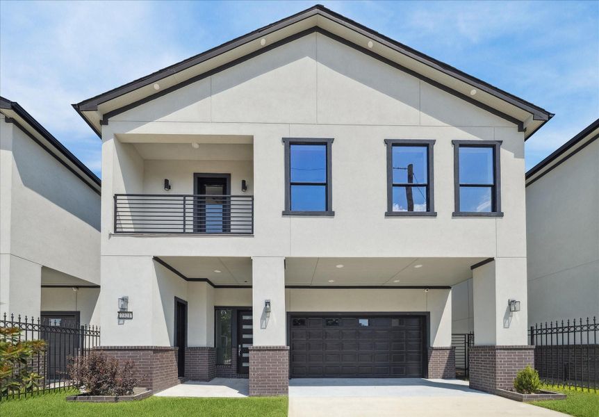 Strong symmetry and clean design highlight the front of the home. A private balcony adds character to the upper level, while the wide garage and driveway ensure everyday convenience.