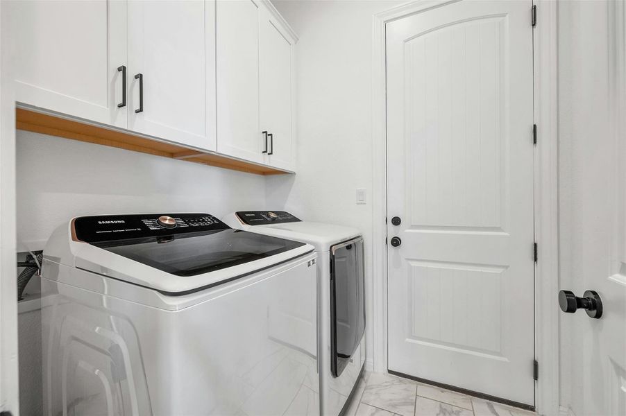 The in home laundry room is situated at the garage entry and opens into the kitchen.