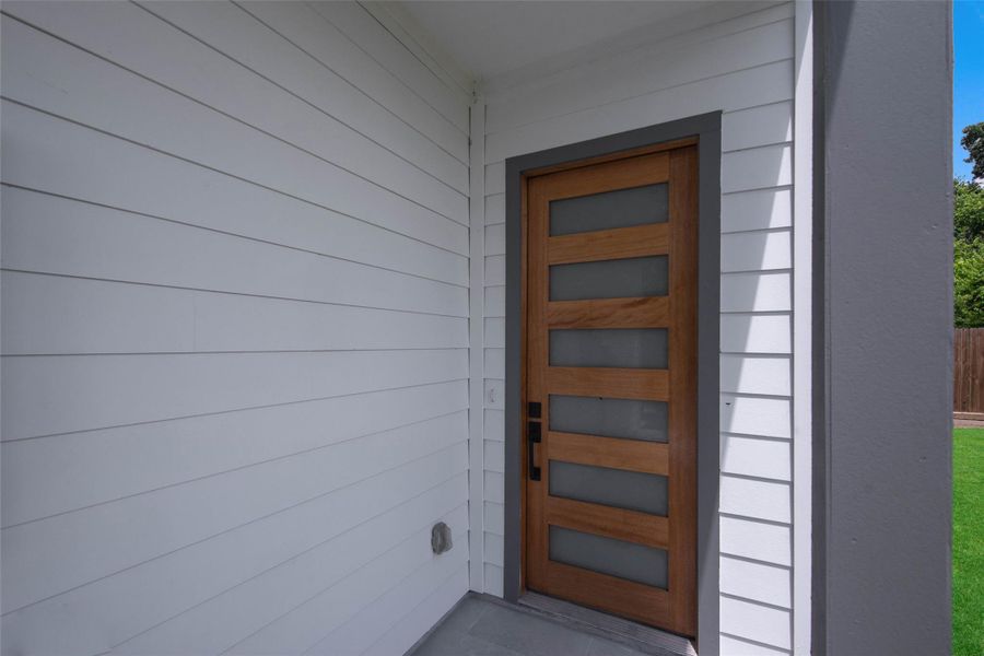 The striking modern entrance with an inviting covered entryway creates a bold yet welcoming first impression. The striking modern entrance with an inviting covered entryway creates a bold yet welcoming first impression.