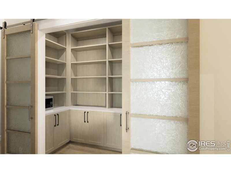 Elegant walk-in pantry with built-in cabinets and barn doors