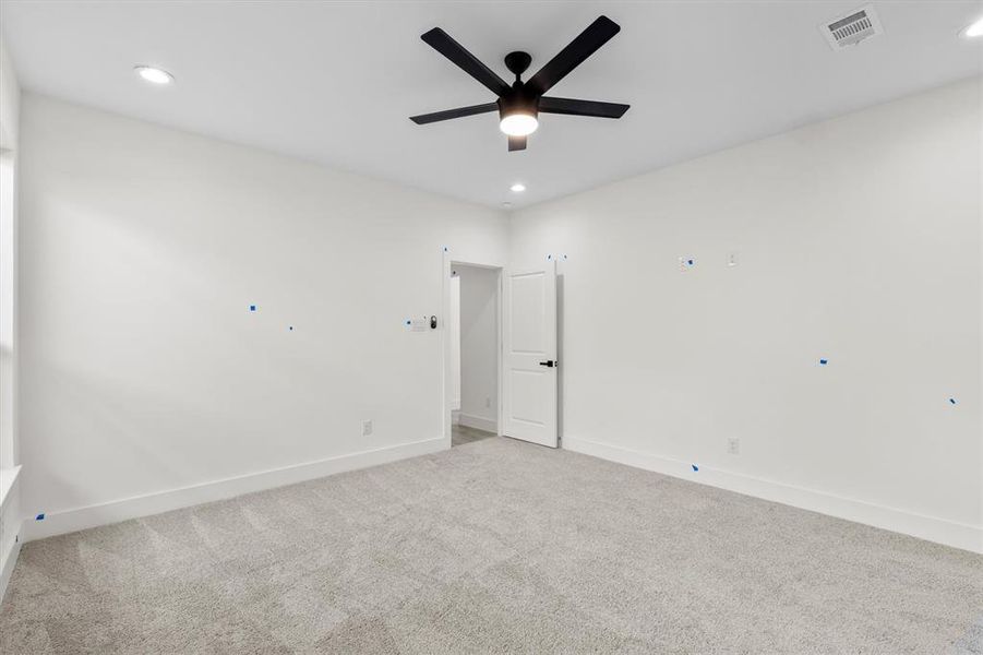 Empty room with ceiling fan and carpet