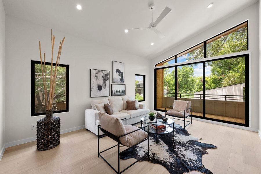 A luminous living area boasts soaring ceilings and extensive glazing, offering abundant natural light. A luminous living area boasts soaring ceilings and extensive glazing, offering abundant natural light.