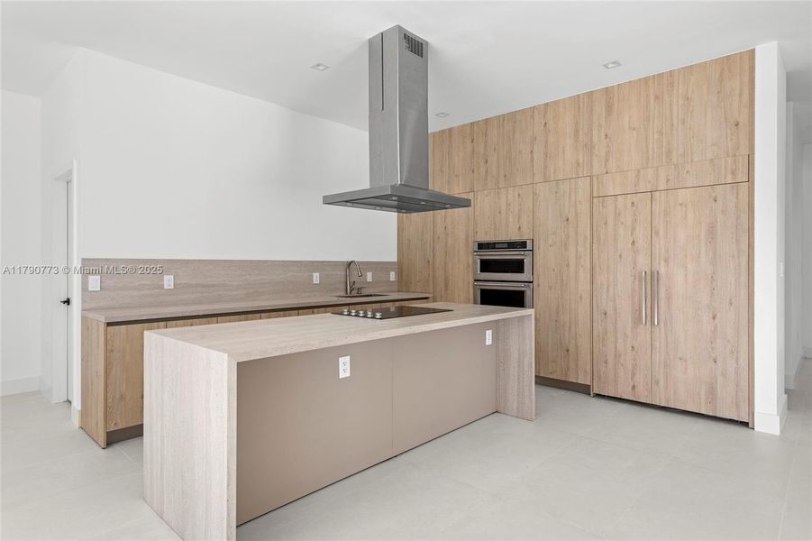 Built-in, panel-ready 48-inch JennAir refrigerator seamlessly integrated into the custom cabinetry, combining high-end performance with sleek, modern design. Built-in, panel-ready 48-inch JennAir refrigerator seamlessly integrated into the custom cabinetry, combining high-end performance with sleek, modern design.