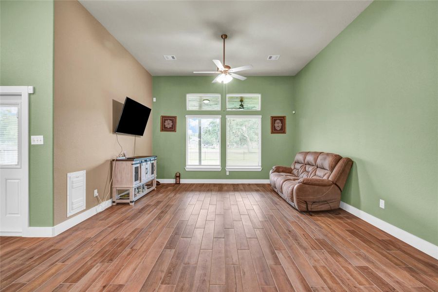 Large living space with windows overlooking the gorgeous covered patio and golf course Large living space with windows overlooking the gorgeous covered patio and golf course
